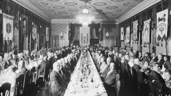 a large group of people sitting at a long table