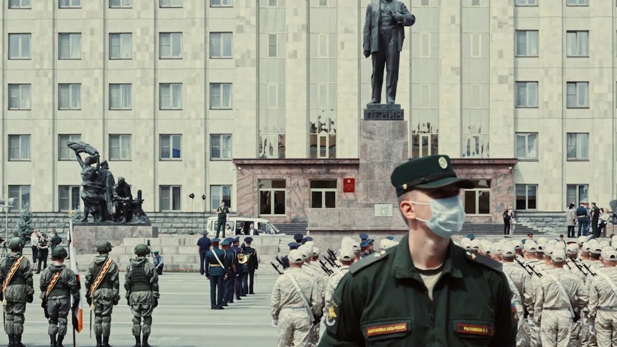 man in green and brown camouflage uniform standing near people in front of building during daytime