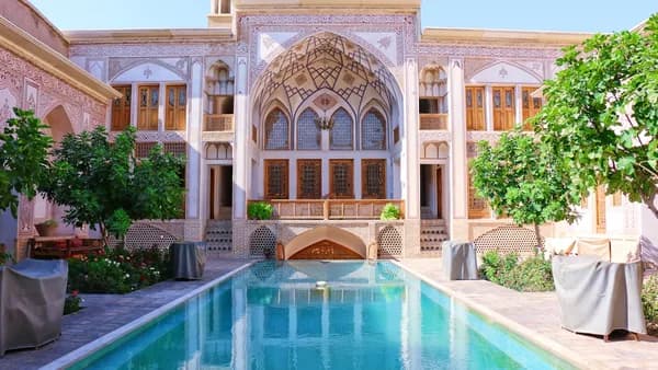 swimming pool near building and trees