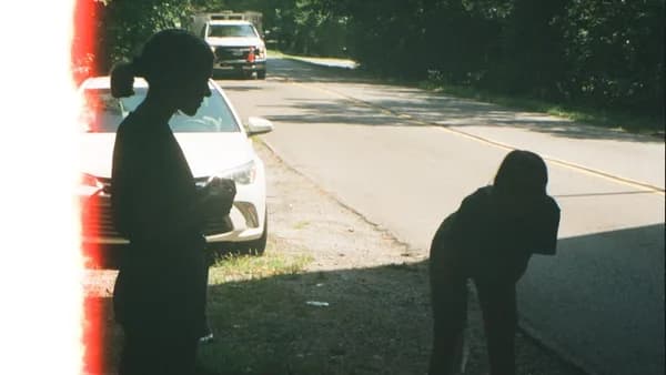 woman standing besides road