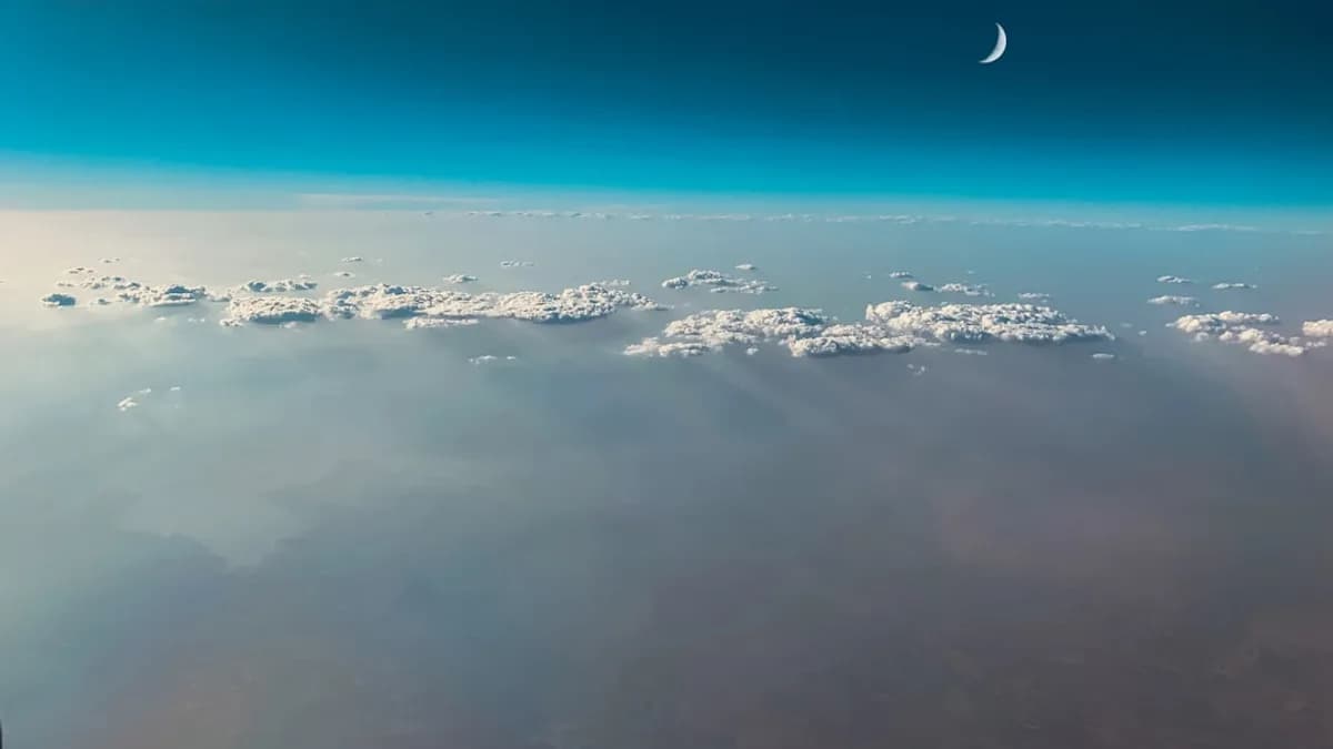 white cloudy skies under crescent moon