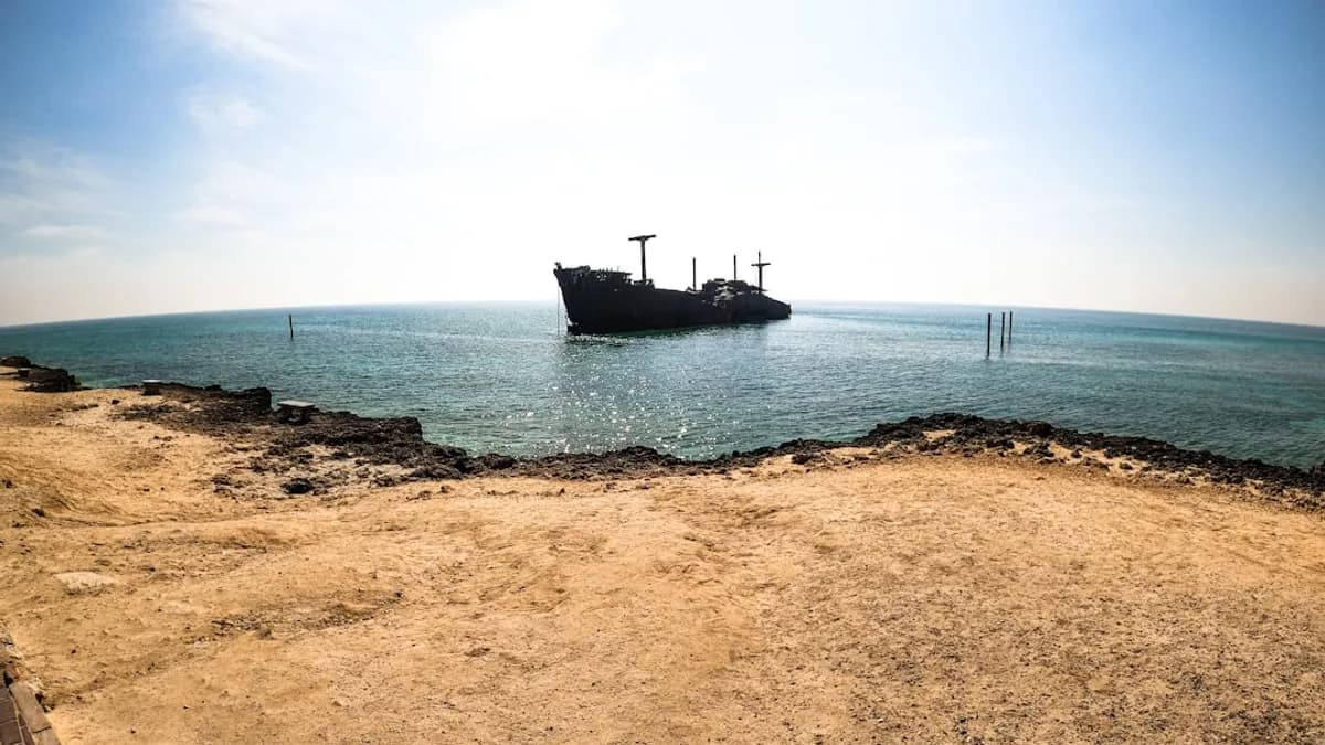 black ship on sea under blue sky during daytime