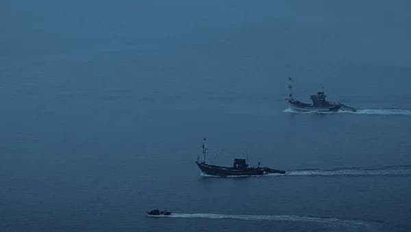 A couple of boats that are in the water