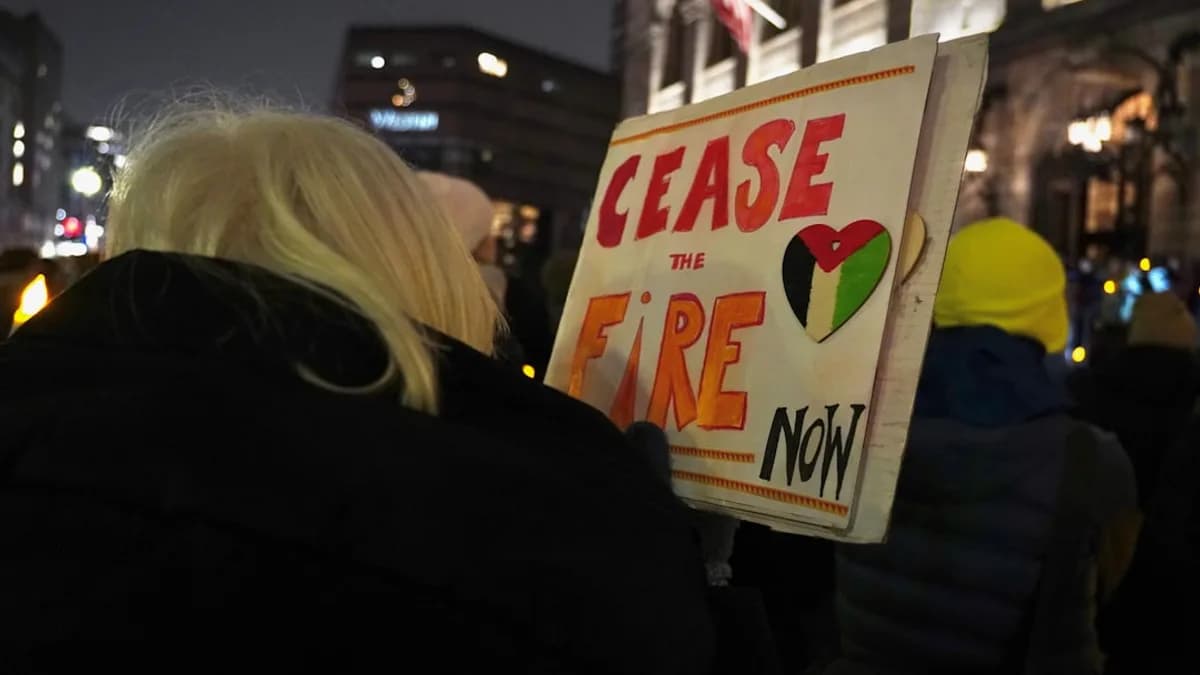 a woman holding a sign that says please the fire now