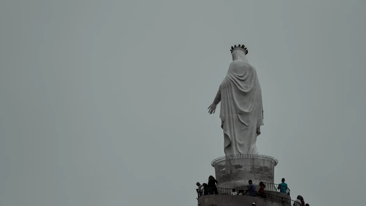 a group of people standing around a statue