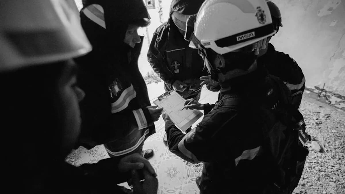 grayscale photo of 2 men in black jacket and helmet