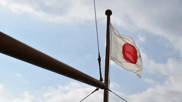 a white and red flag flying on top of a pole