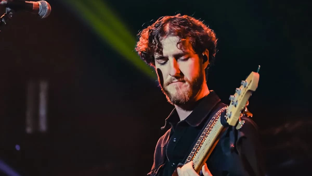 a man playing a guitar on stage at a concert