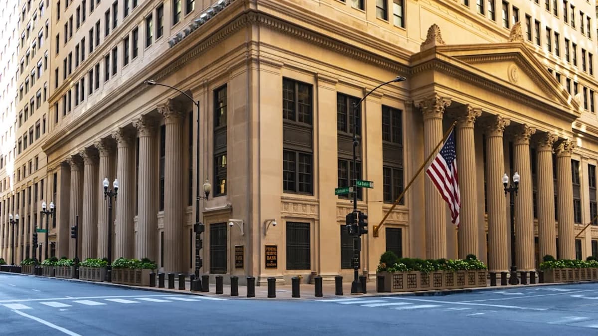 a large building with columns and a flag on the corner