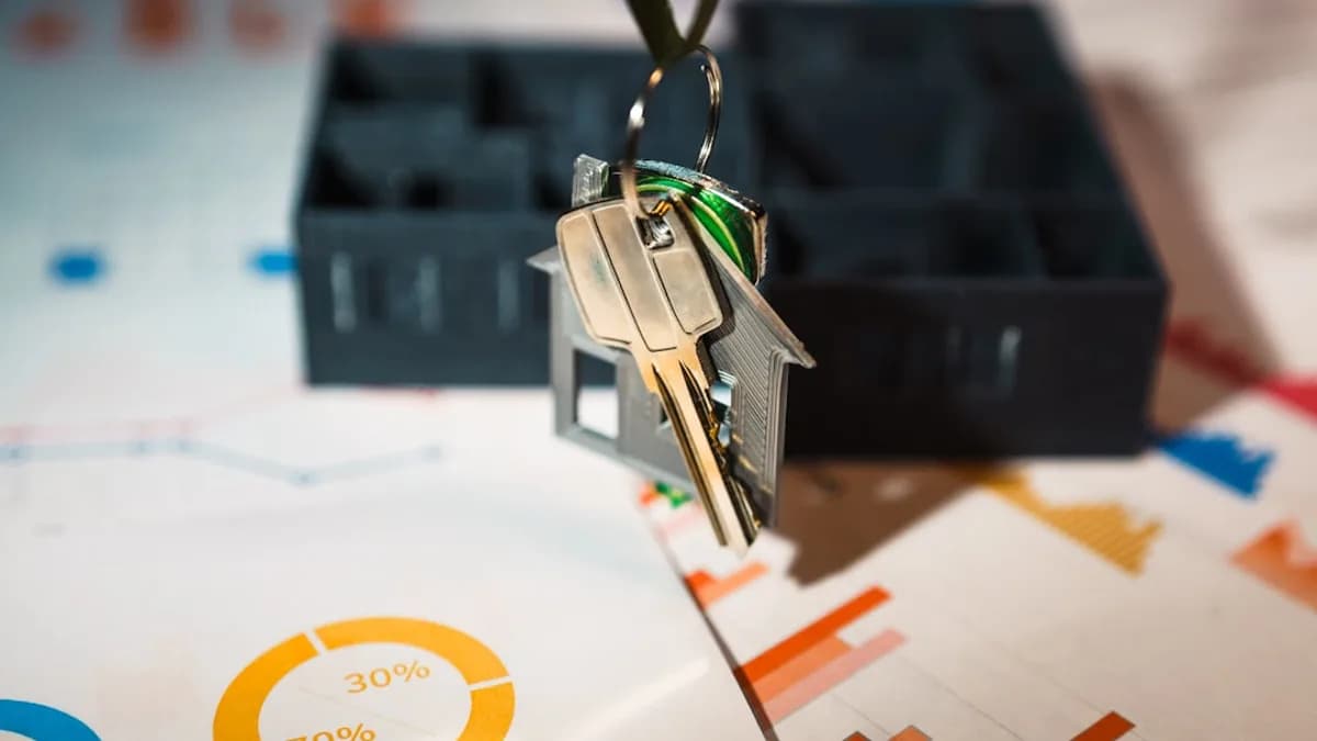 A house shaped keychain hanging from a key chain