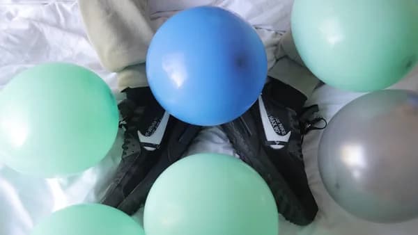 blue and green balloons on black and white textile