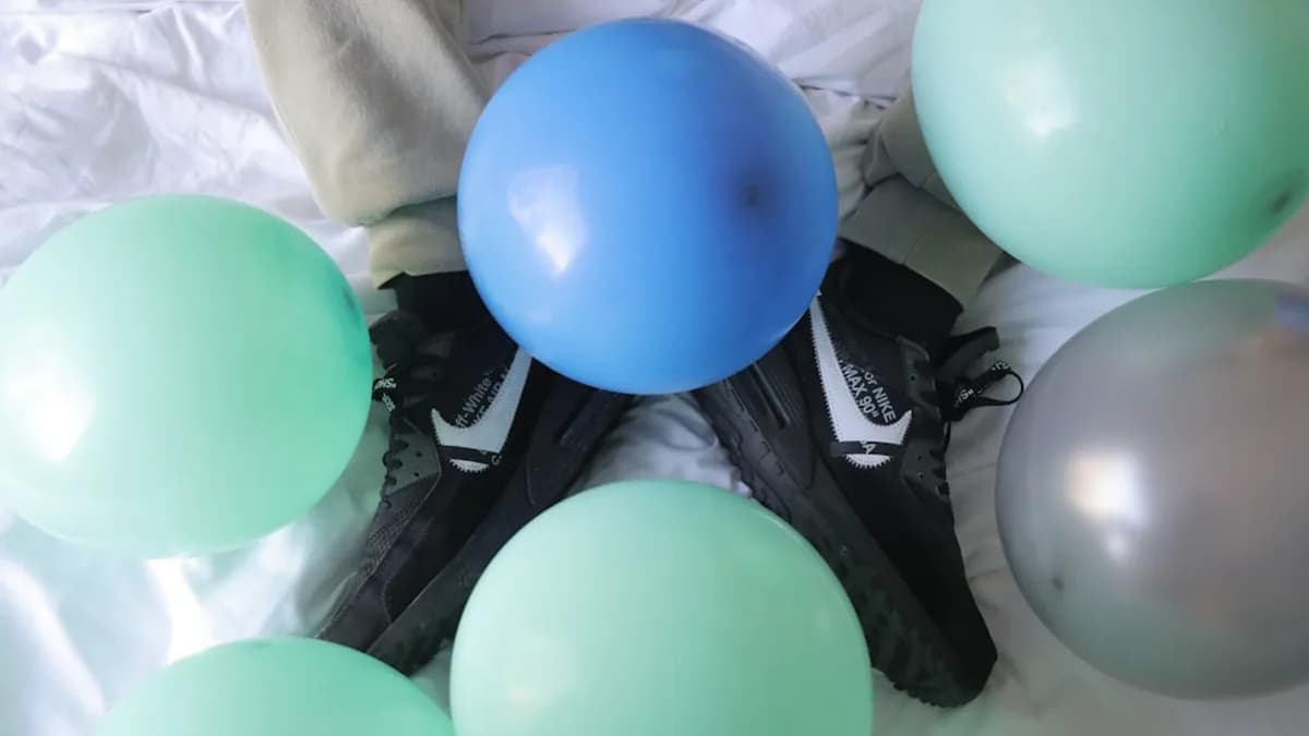 blue and green balloons on black and white textile