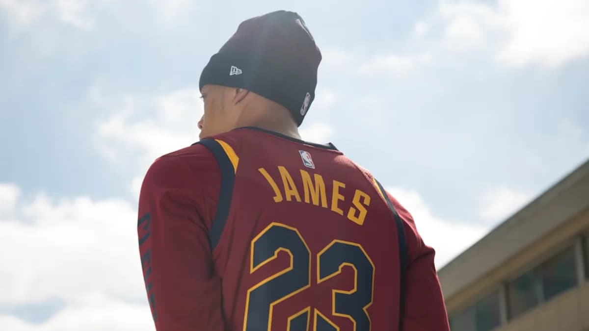 man in black and red long sleeve shirt wearing black cap