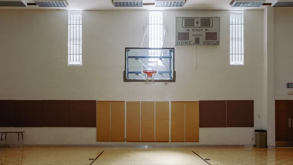 an indoor basketball court with a basketball hoop