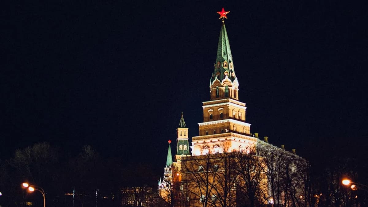 a large building with a steeple lit up at night
