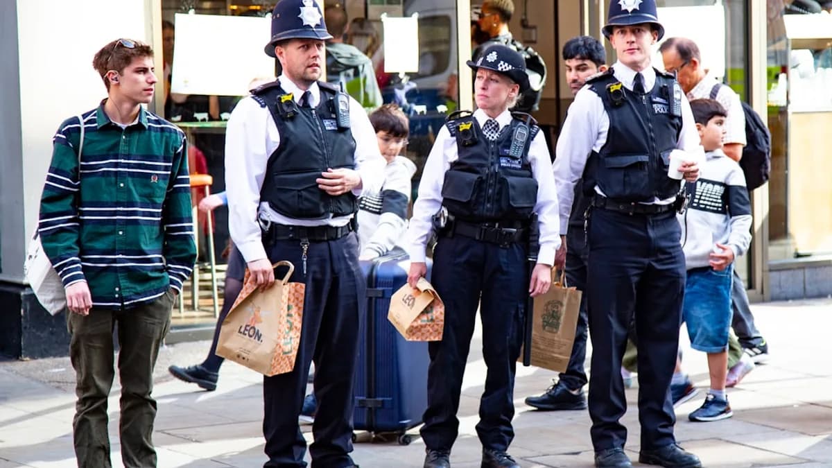 man in green and black uniform holding brown paper bag