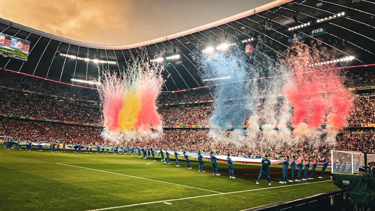A stadium filled with lots of people watching a soccer game