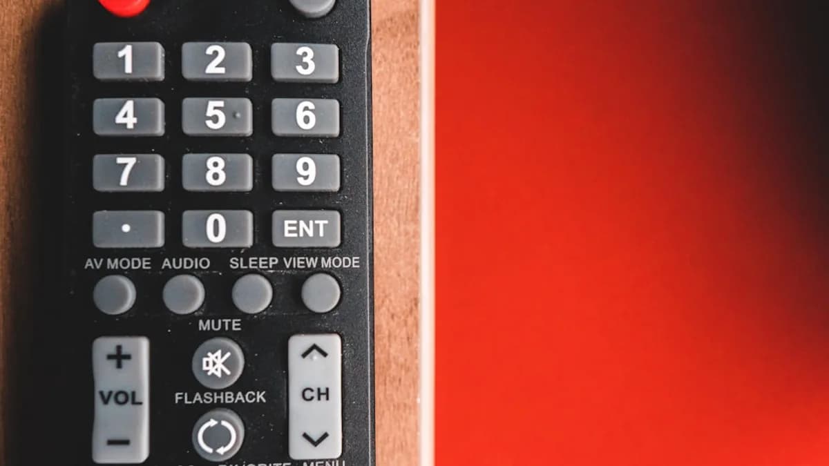 black remote control on red surface