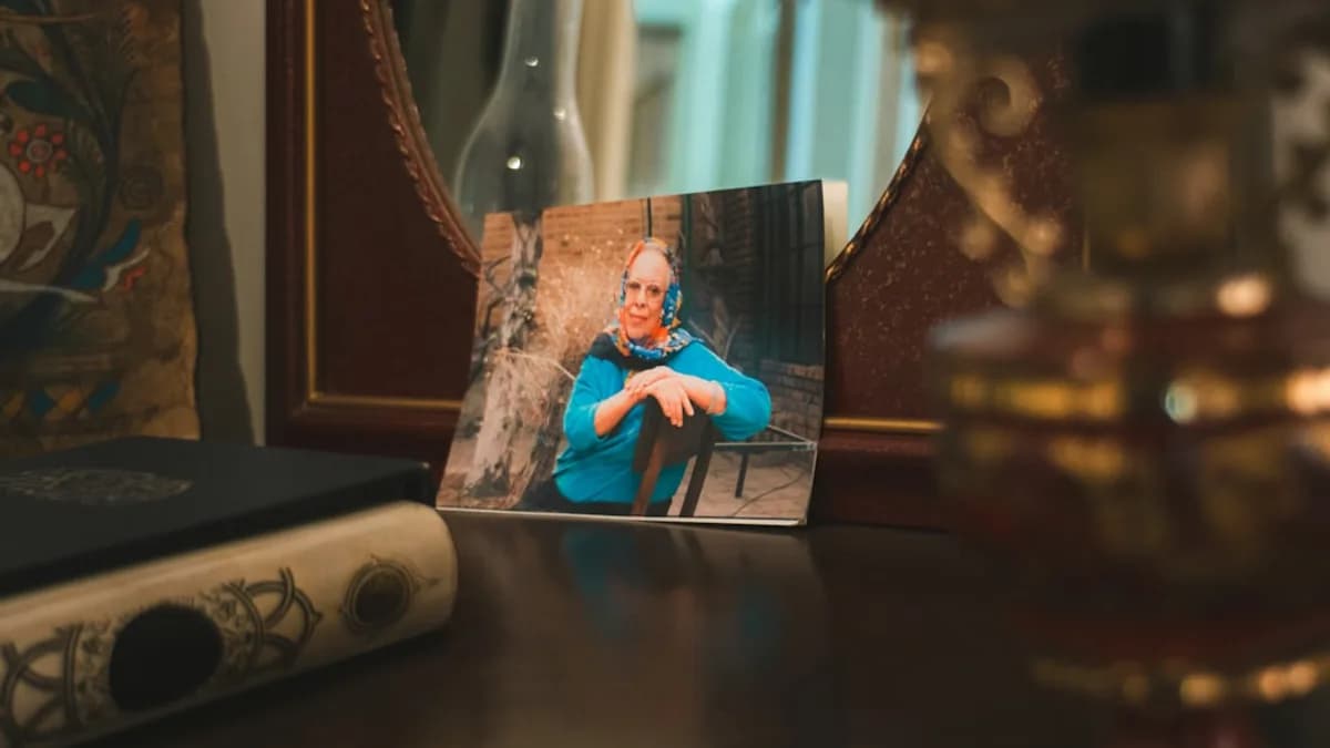 A framed photograph of a person in a blue shirt.