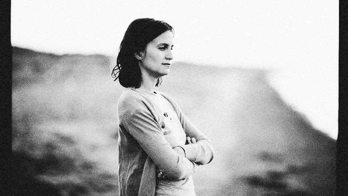 a black and white photo of a woman with her arms crossed