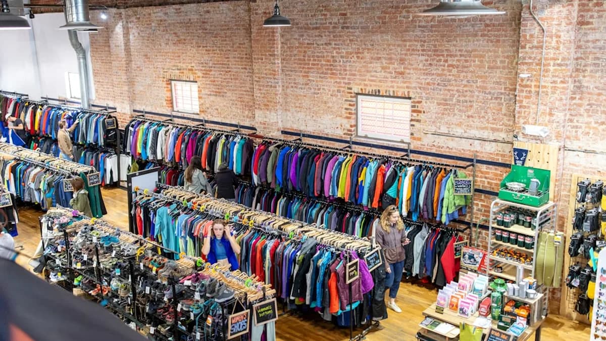 Retail store interior with racks of colorful clothing.