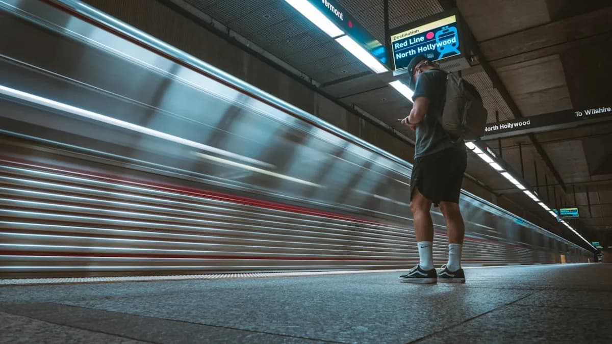 woman in black jacket and black pants walking on sidewalk