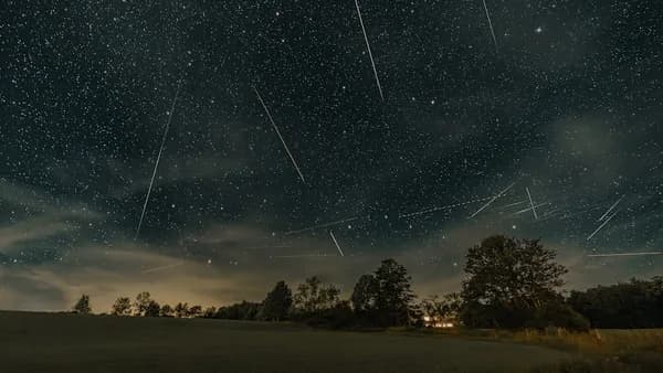 a night sky filled with stars and shooting stars