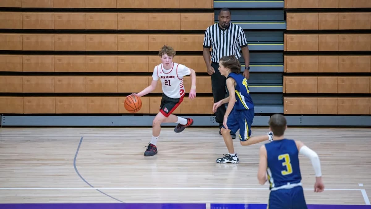 a group of young men playing a game of basketball
