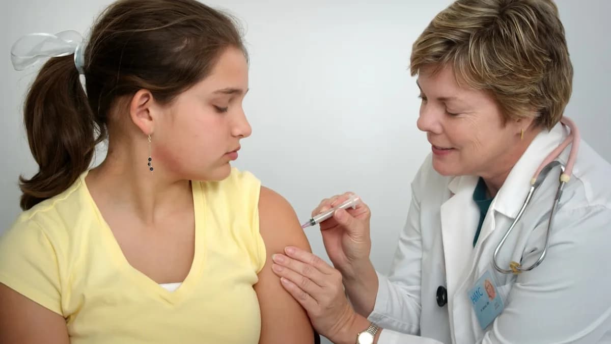 woman injecting girl's left arm