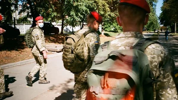 men in camouflage uniform standing on ground during daytime