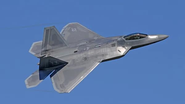 flying gray jet plane