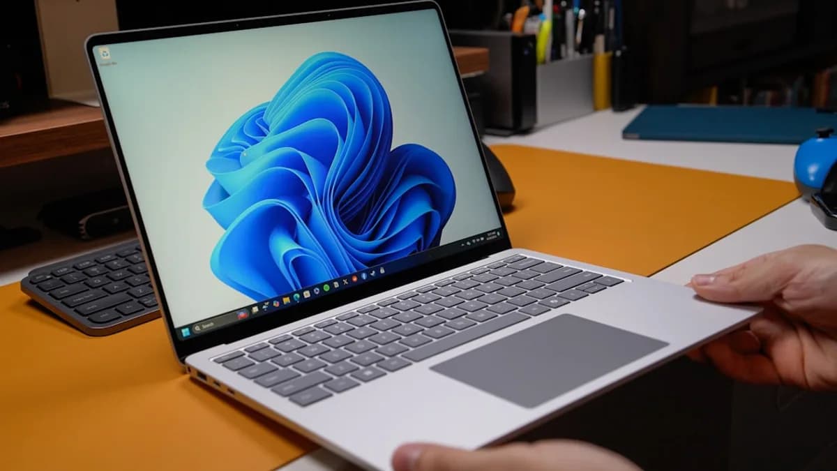 Hands holding a modern laptop with windows 11