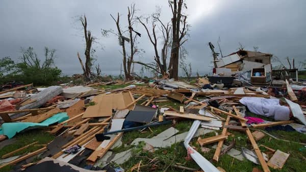 a pile of debris sitting on top of a lush green field