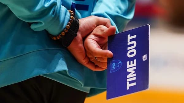 Person holding a blue time out sign