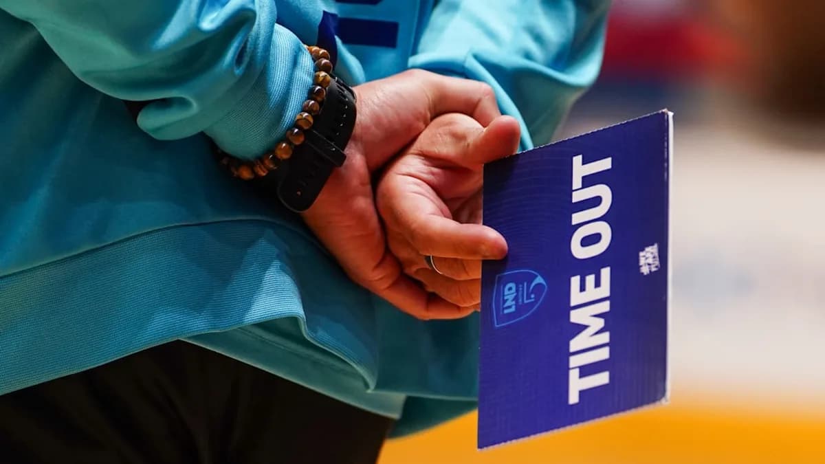 Person holding a blue time out sign