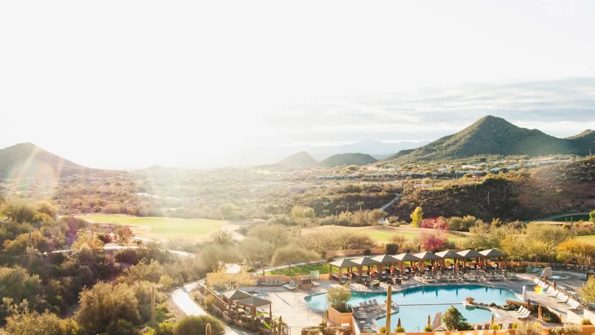 An aerial view of a resort surrounded by mountains