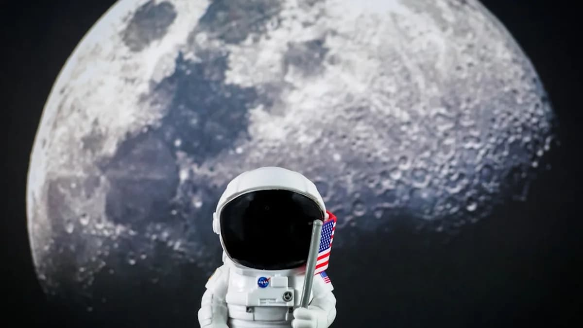 an astronaut holding a flag in front of a full moon