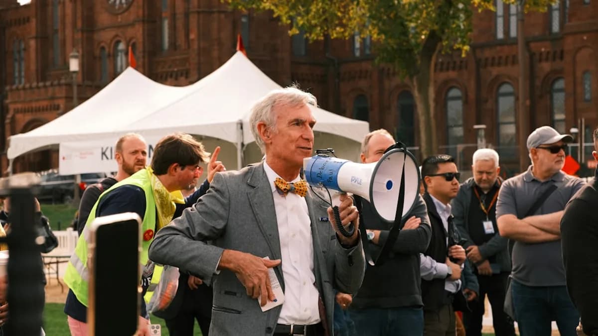 Man with megaphone speaking to a crowd