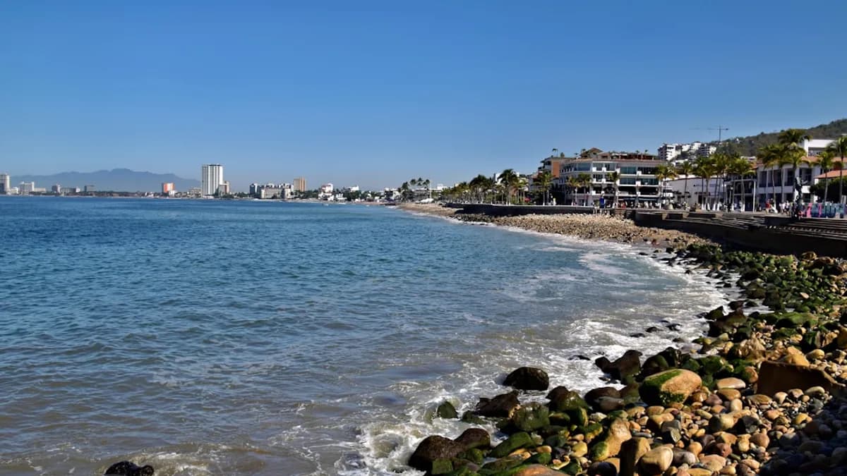 A beautiful ocean view with buildings and a blue sky.