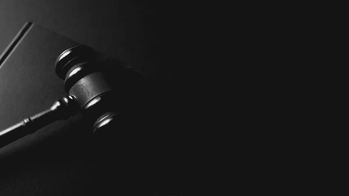 A gavel rests on a dark background.