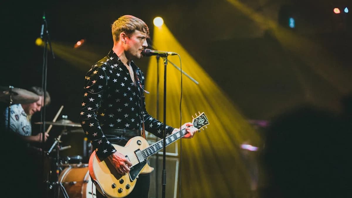 a man playing a guitar on a stage