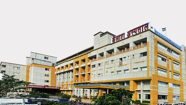 a yellow and white building with a red sign on top of it