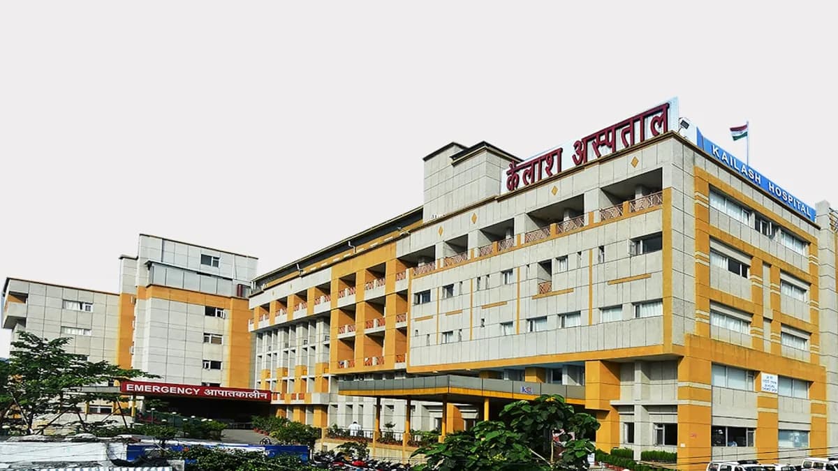 a yellow and white building with a red sign on top of it