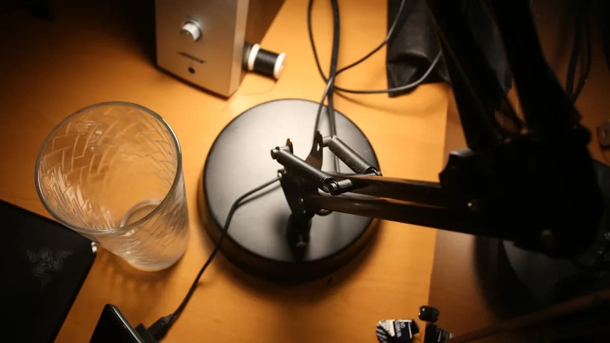 black and silver microphone on brown wooden table