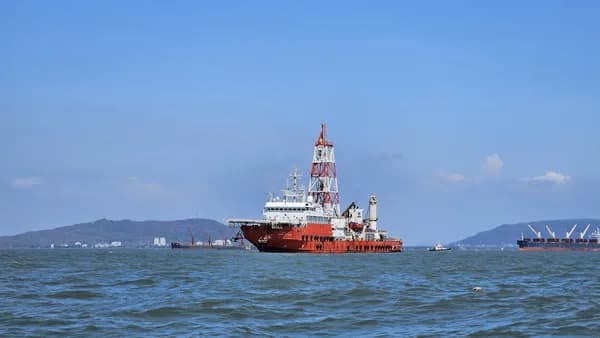 A drilling ship is floating on the water.