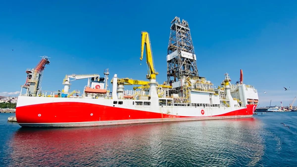 red and white ship on sea under blue sky during daytime