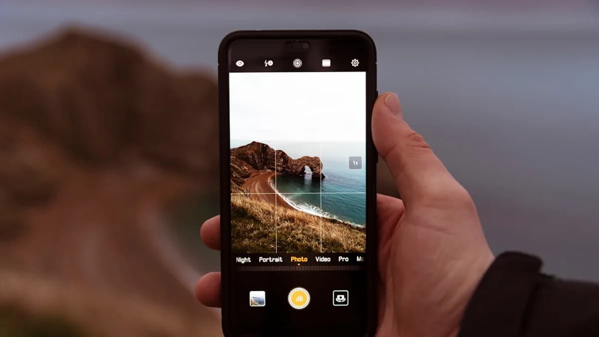 person taking photo of rock formation