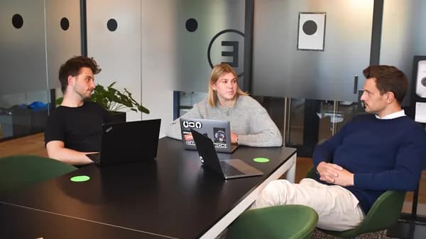 woman in gray sweater sitting on green chair