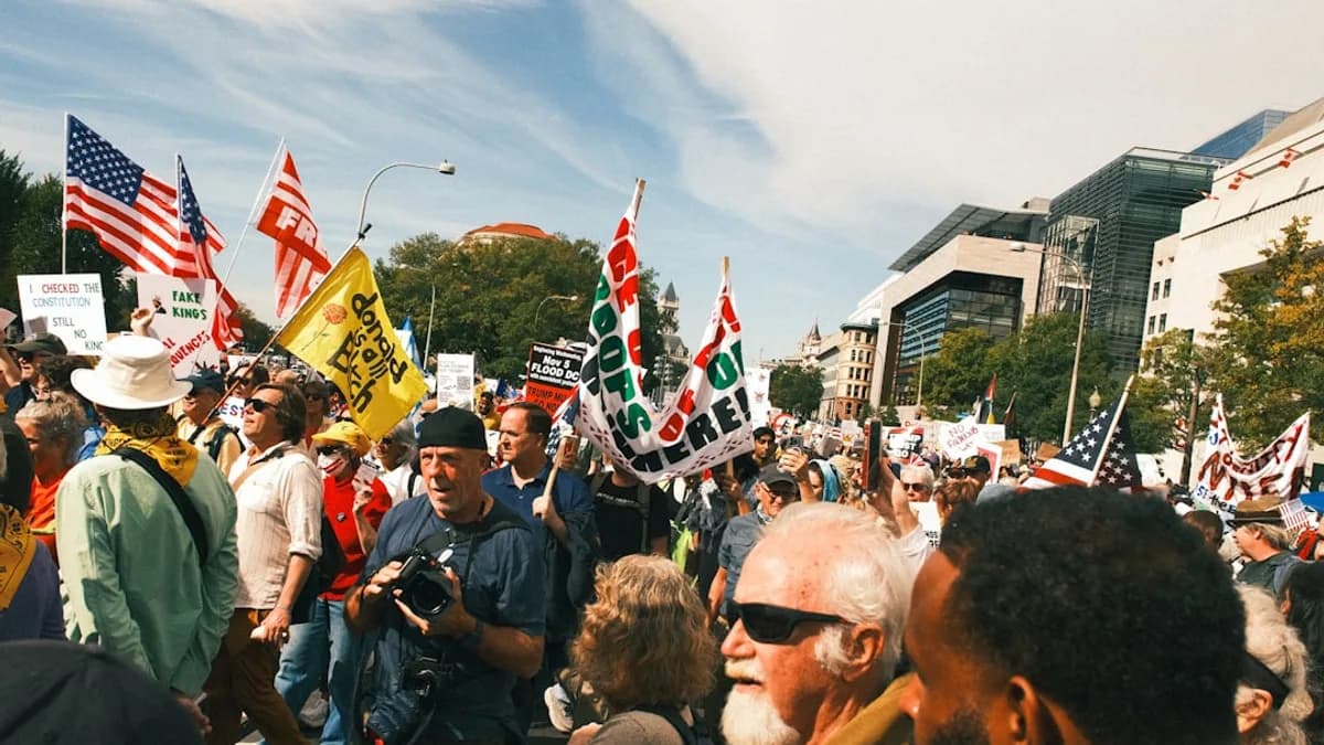 Crowd of people holding flags at a rally