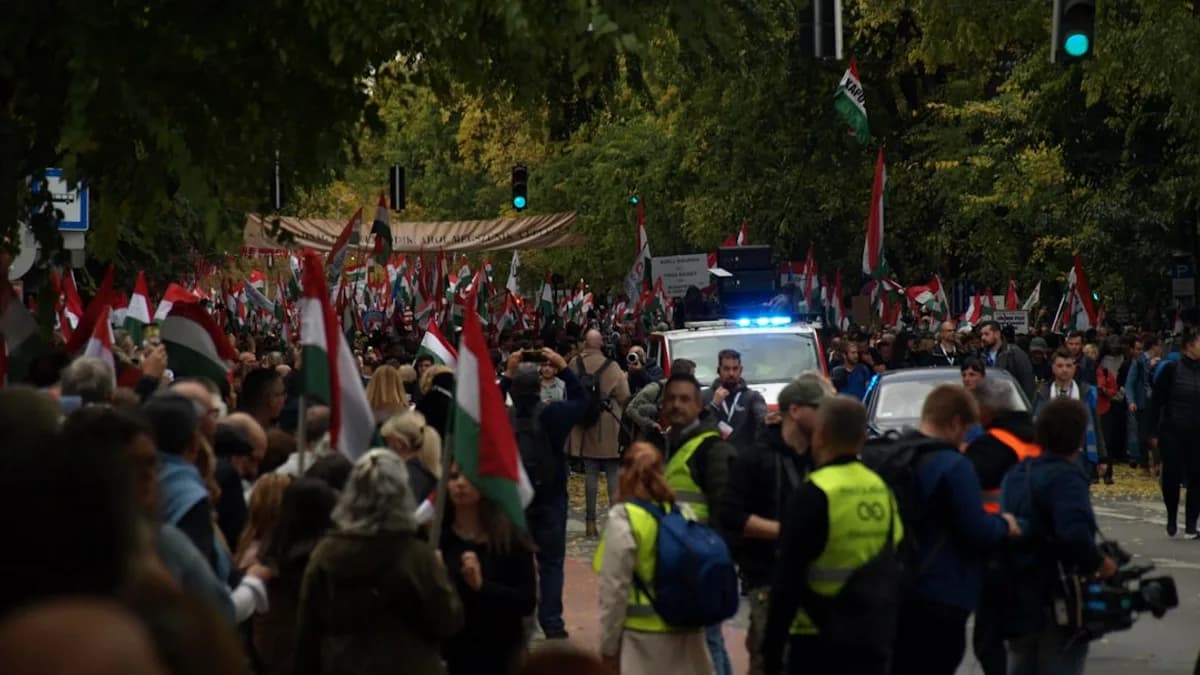 Crowd of people waving hungarian flags near police car
